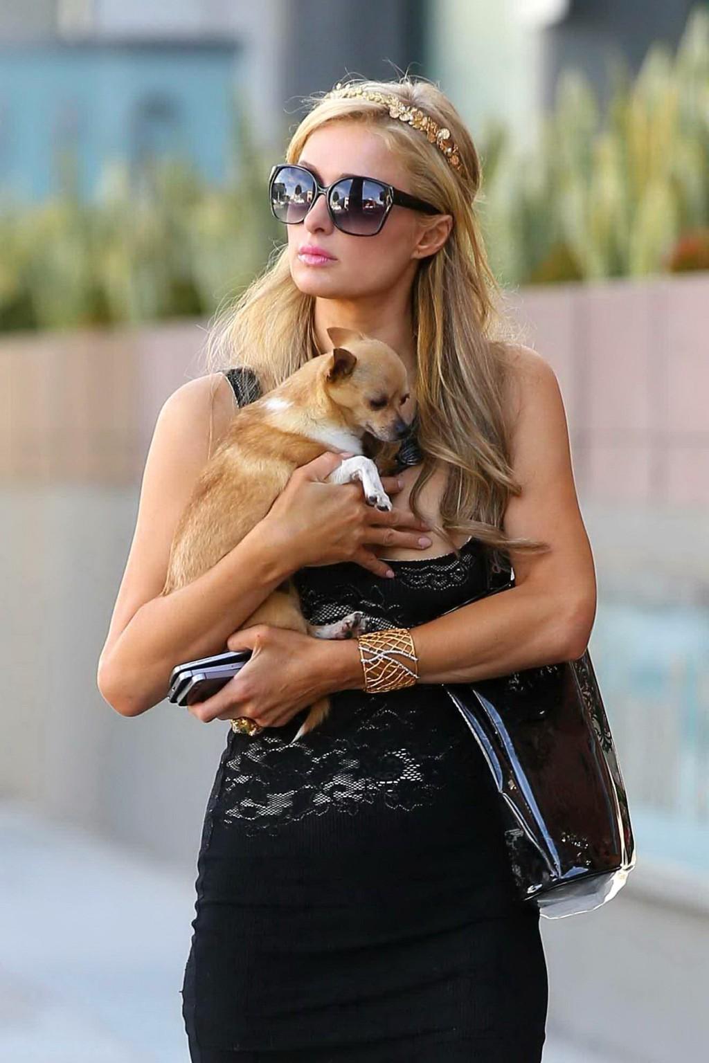 14P Paris Hilton shows huge cleavage wearing a low cut dress out in LA