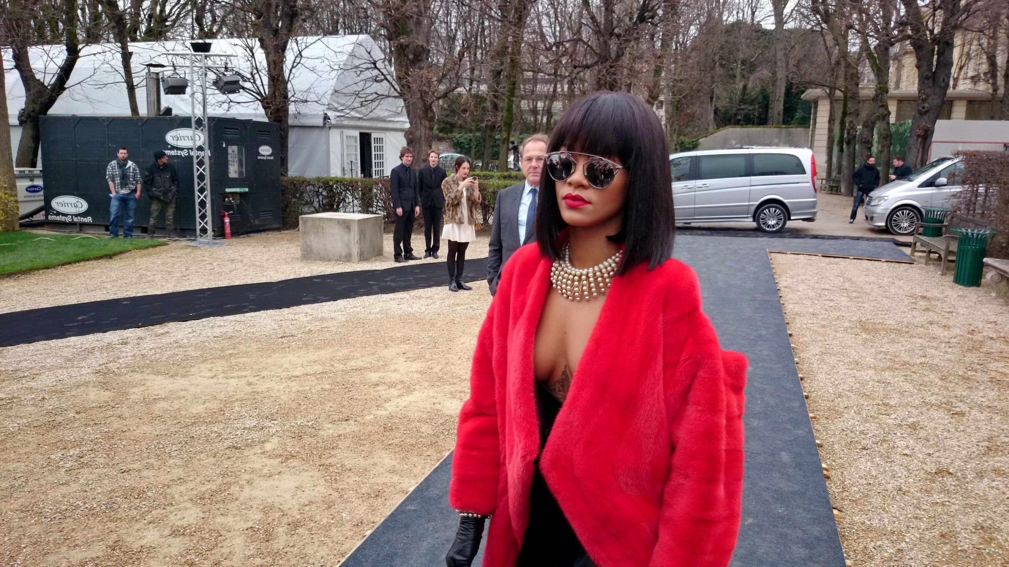 16P Rihanna showing off her stockings and cleavage at the Christian Dior fashion sho