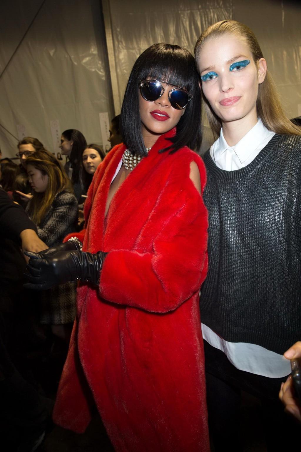 16P Rihanna showing off her stockings and cleavage at the Christian Dior fashion sho