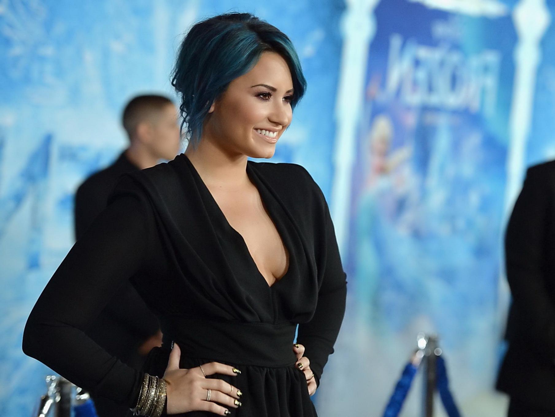 16P Demi Lovato braless showing big cleavage in a tight black outfit at the Frozen p