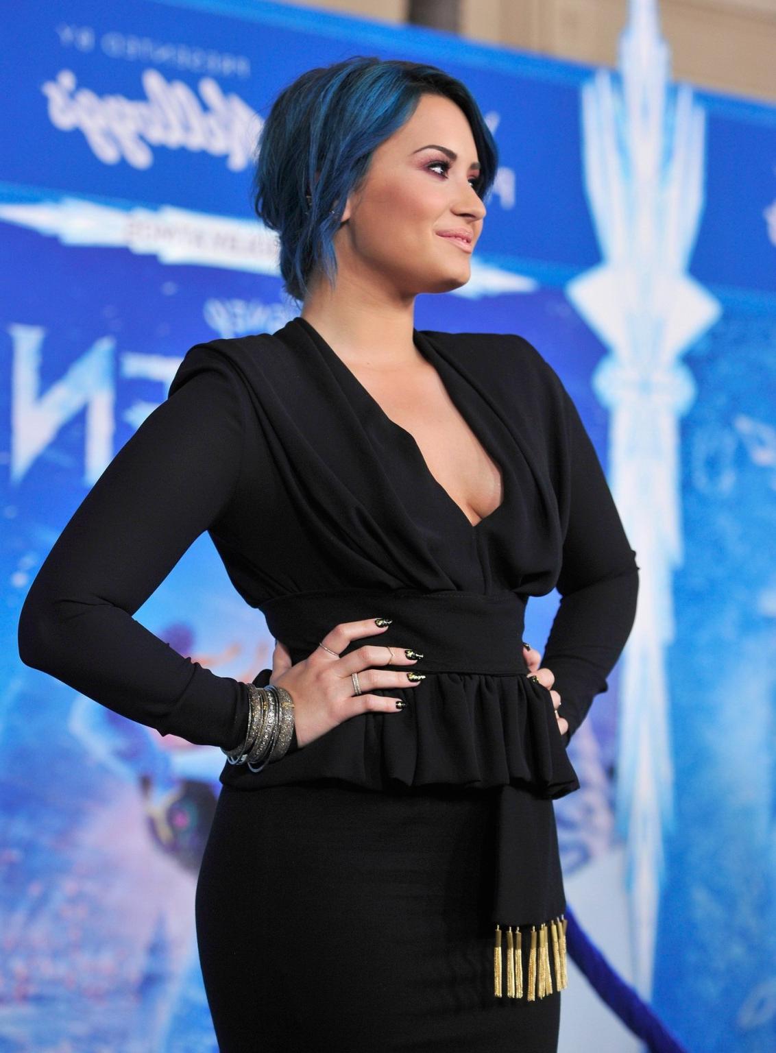 16P Demi Lovato braless showing big cleavage in a tight black outfit at the Frozen p