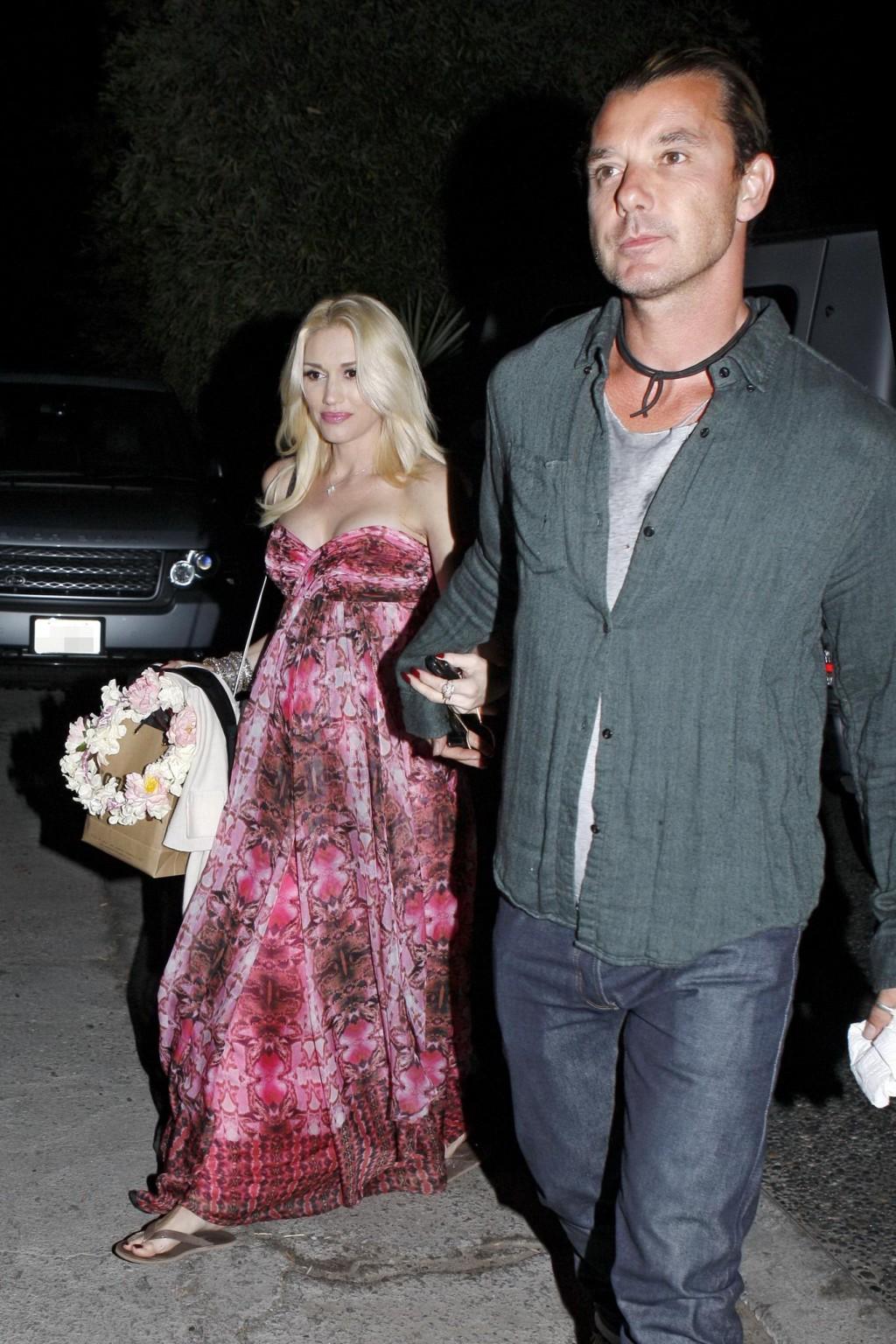 16P Gwen Stefani shows off her breast implants wearing a strapless dress outside a f