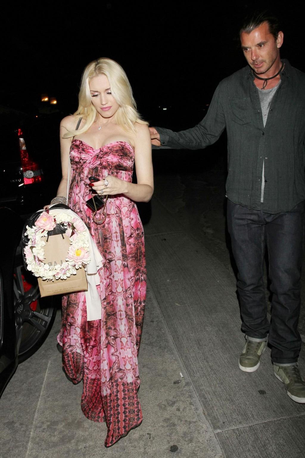 16P Gwen Stefani shows off her breast implants wearing a strapless dress outside a f