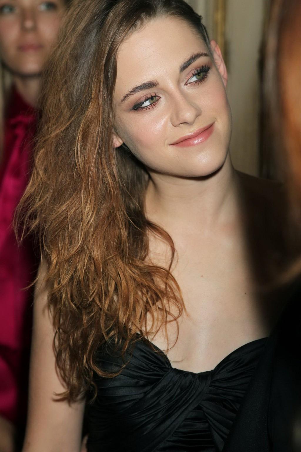 16P Kristen Stewart showing huge cleavage in black tube top and see-through pants at