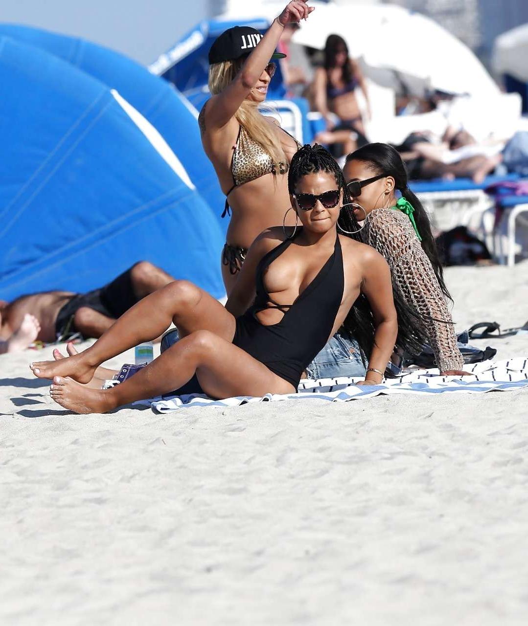 16P Christina Milian exposing nipples slip in bikini on beach