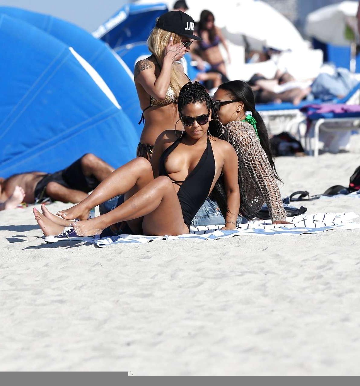 16P Christina Milian exposing nipples slip in bikini on beach