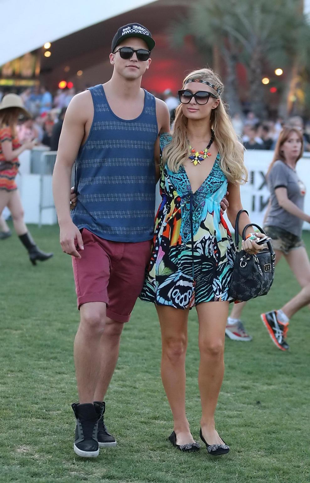16P Paris Hilton braless showing huge cleavage in a colorful mini dress at 2013 Coac