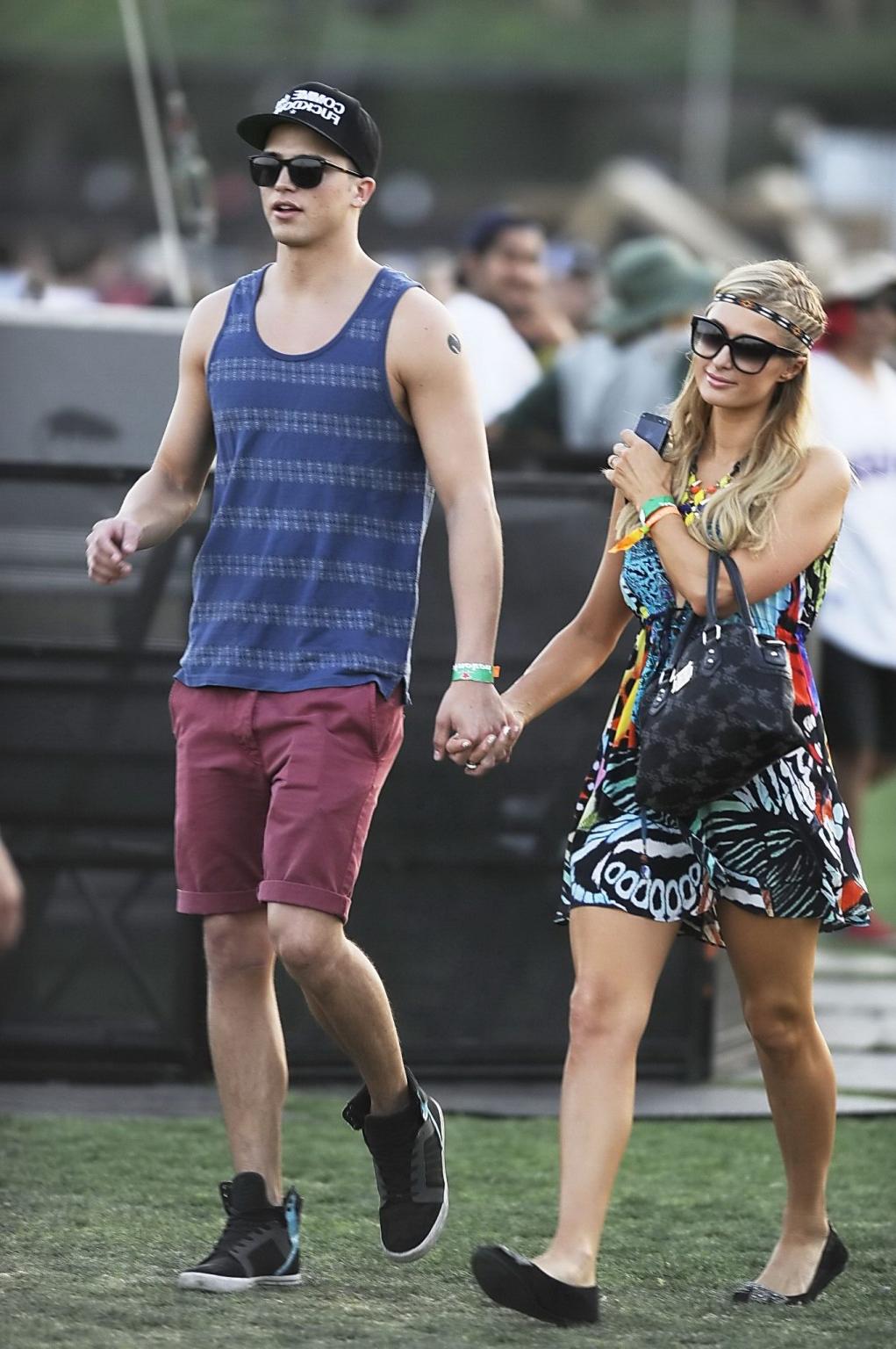 16P Paris Hilton braless showing huge cleavage in a colorful mini dress at 2013 Coac