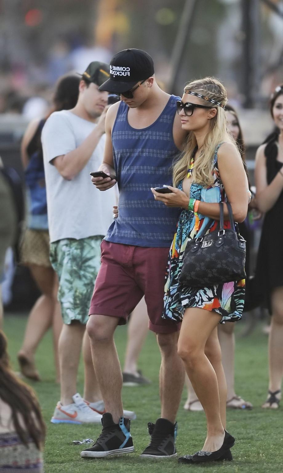 16P Paris Hilton braless showing huge cleavage in a colorful mini dress at 2013 Coac