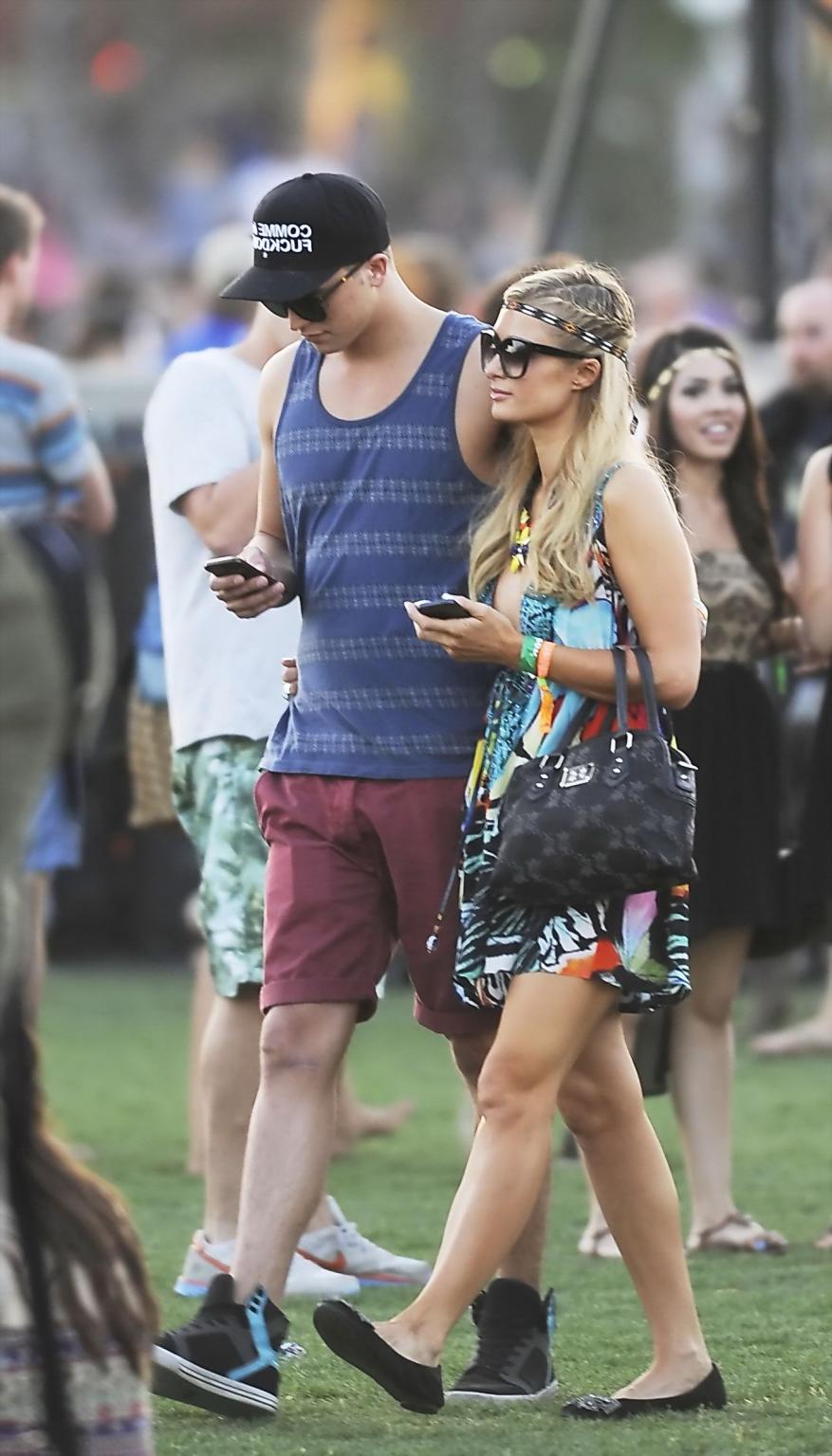 16P Paris Hilton braless showing huge cleavage in a colorful mini dress at 2013 Coac