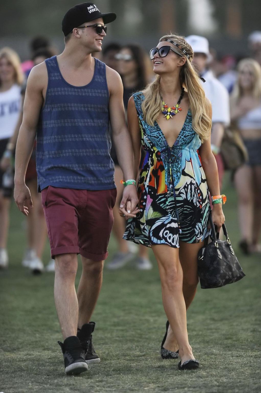 16P Paris Hilton braless showing huge cleavage in a colorful mini dress at 2013 Coac