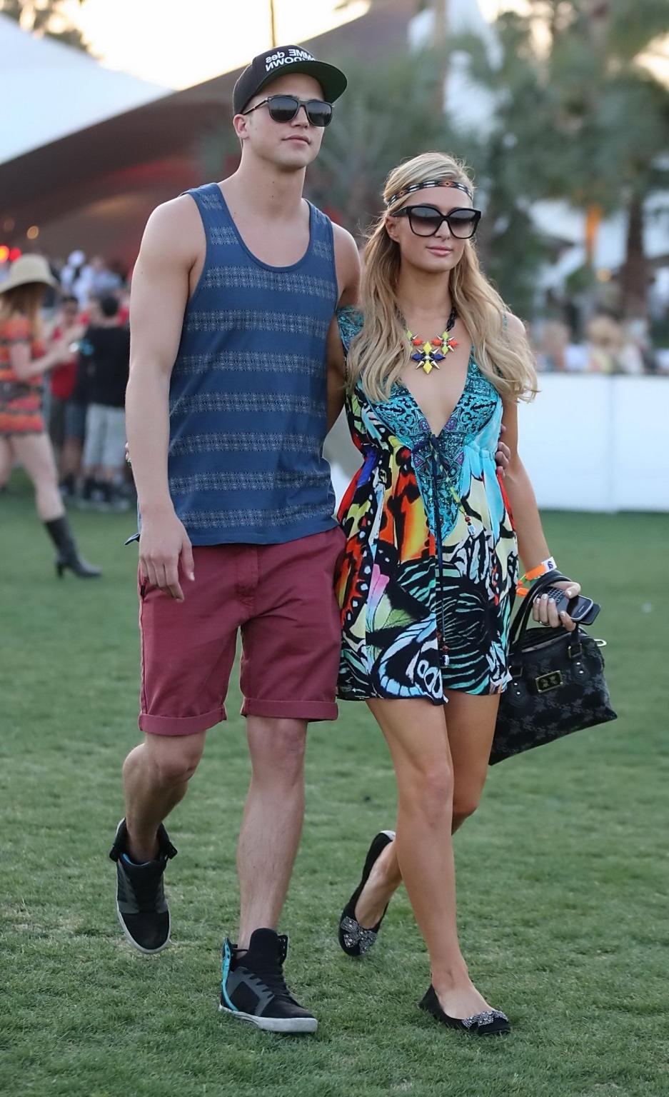 16P Paris Hilton braless showing huge cleavage in a colorful mini dress at 2013 Coac