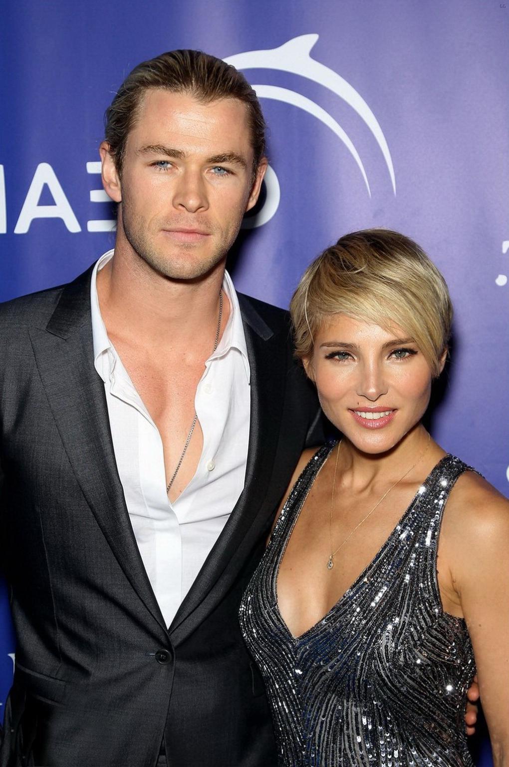 16P Elsa Pataky braless showing huge cleavage in a shiny gray backless mini dress at