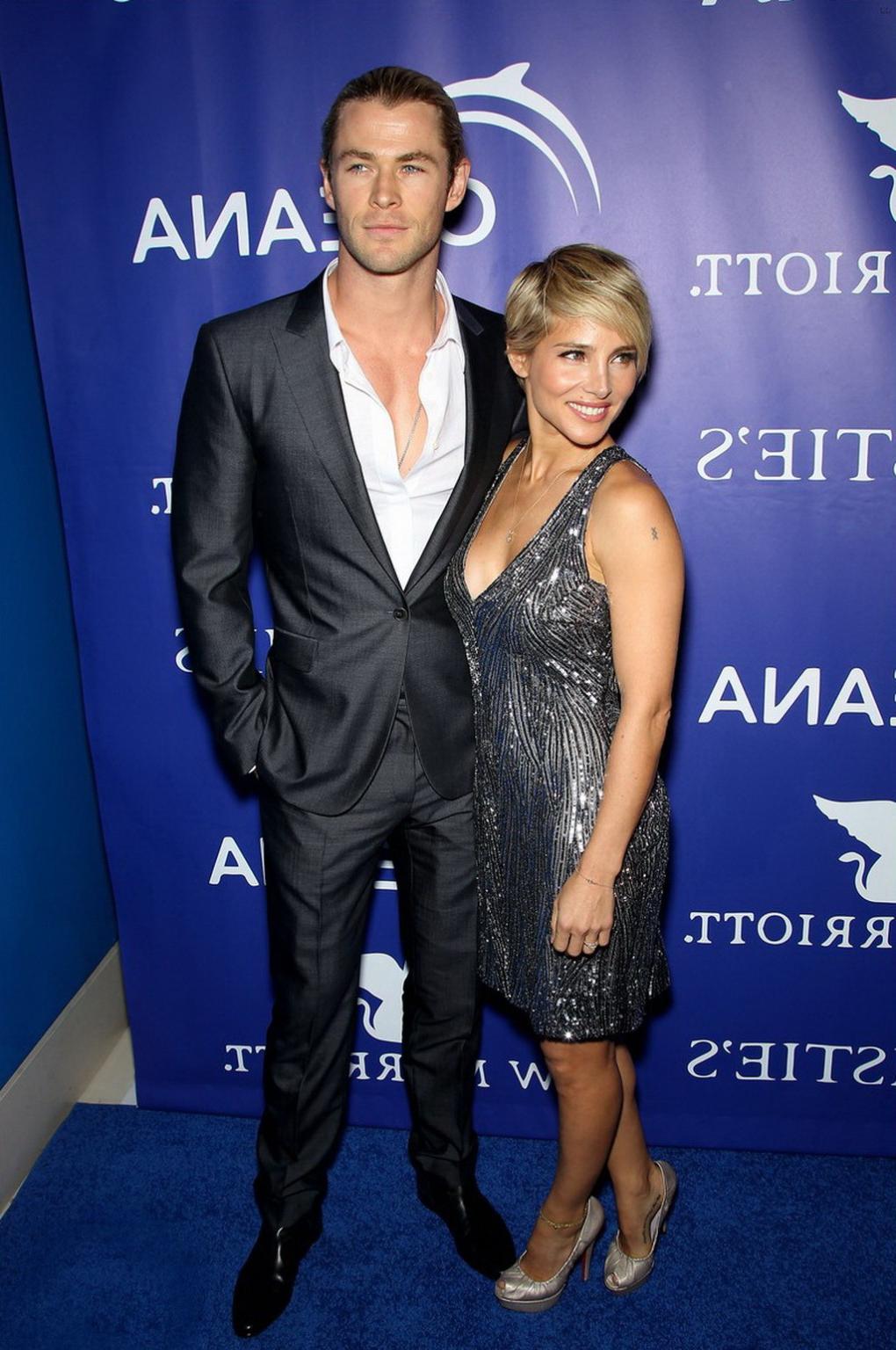 16P Elsa Pataky braless showing huge cleavage in a shiny gray backless mini dress at