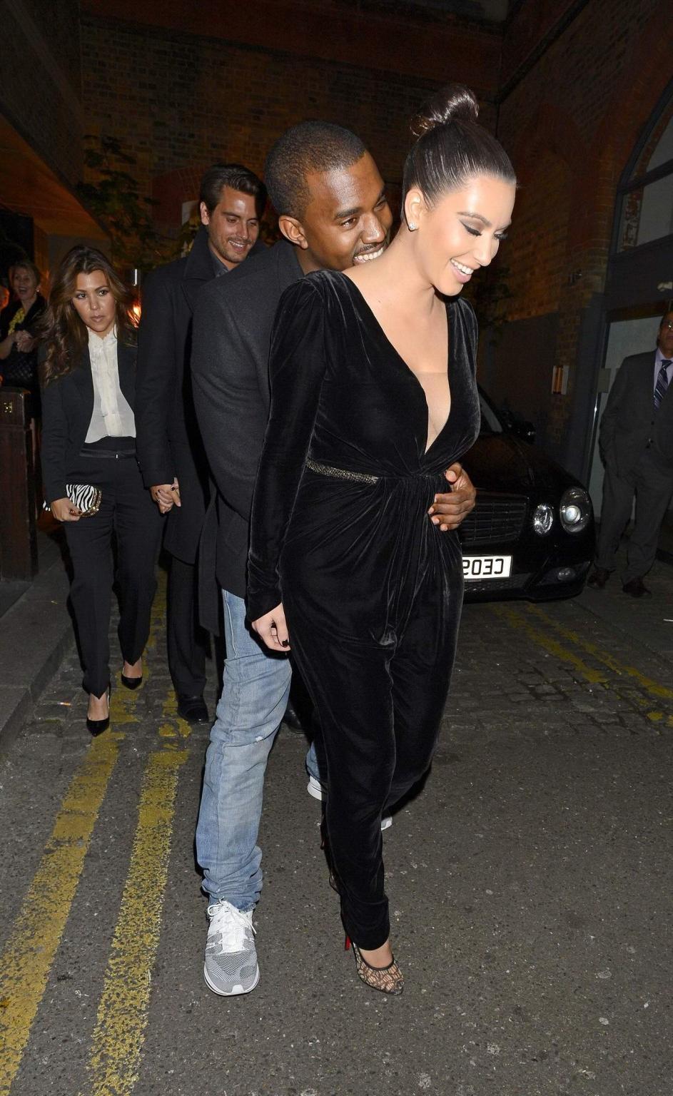 10P Kim Kardashian shows cleavage  pokies wearing a sexy black outfit outside a rest