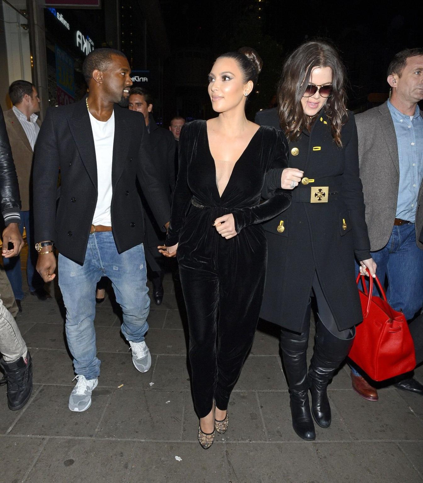 10P Kim Kardashian shows cleavage  pokies wearing a sexy black outfit outside a rest