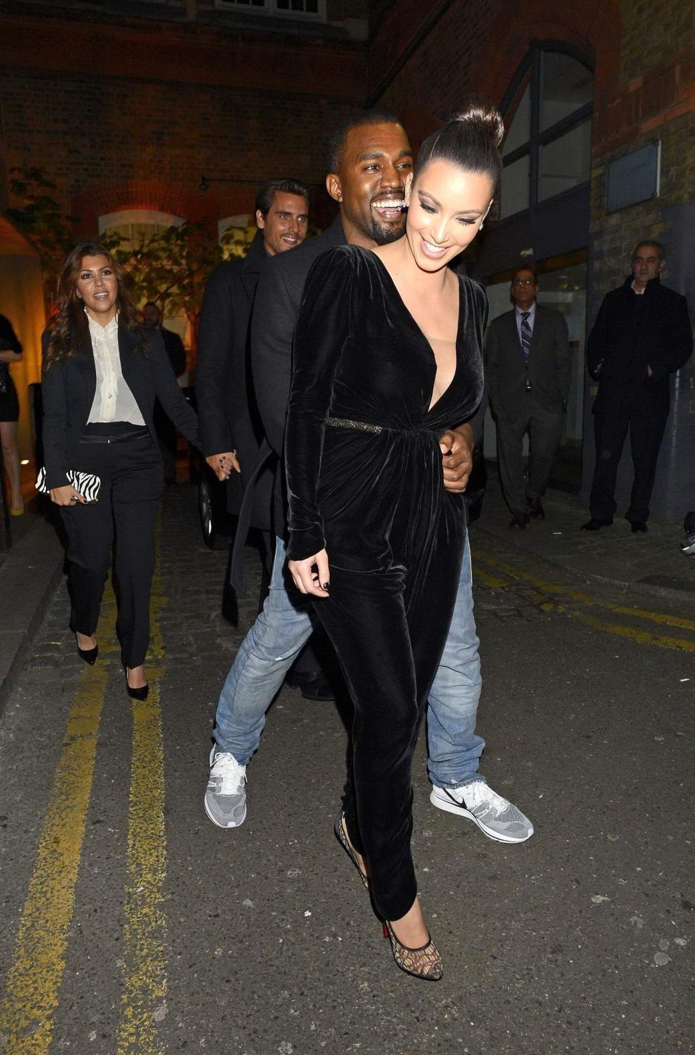 10P Kim Kardashian shows cleavage  pokies wearing a sexy black outfit outside a rest