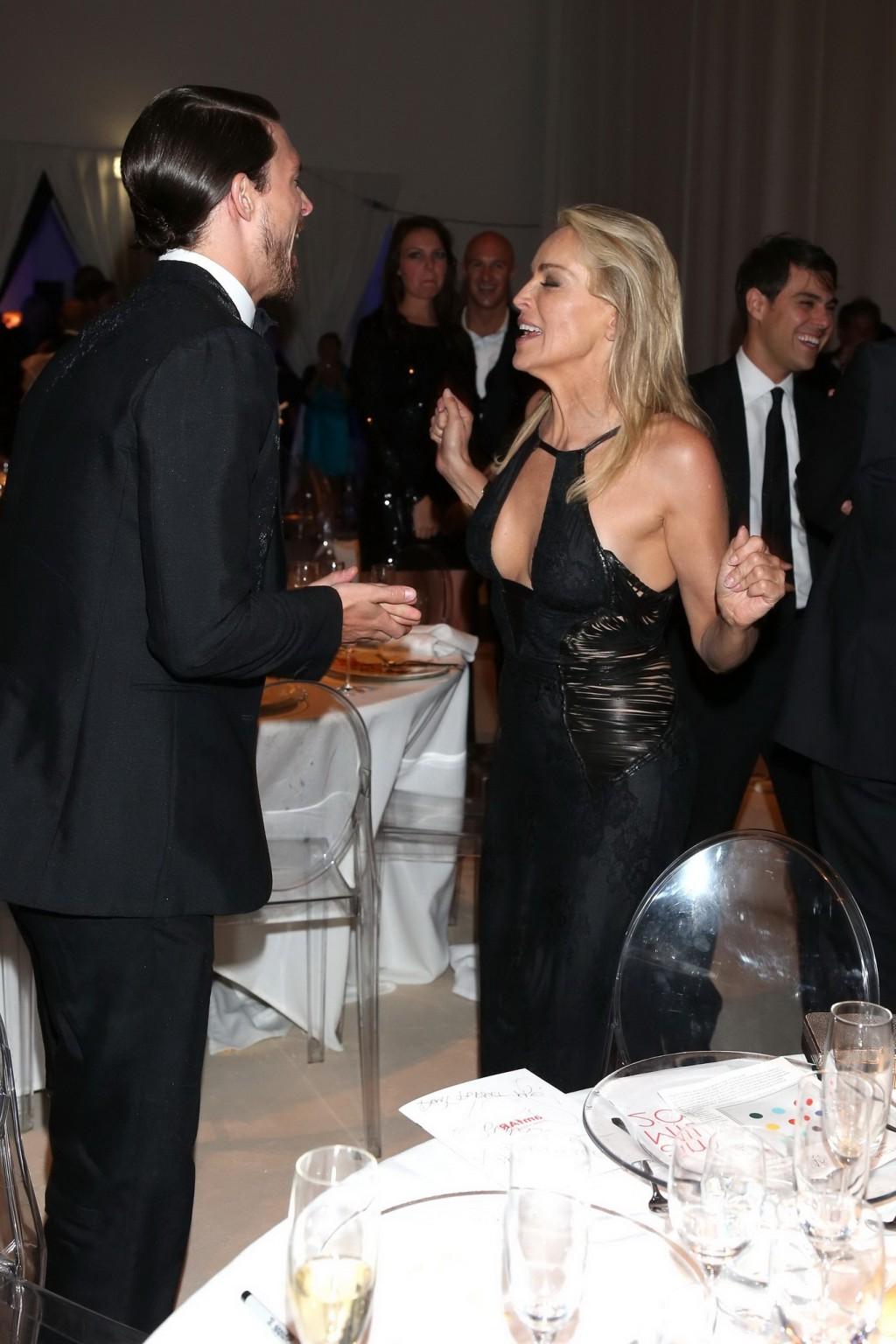 10P Sharon Stone showing cleavage at amfAR event during Milan Fashion Week
