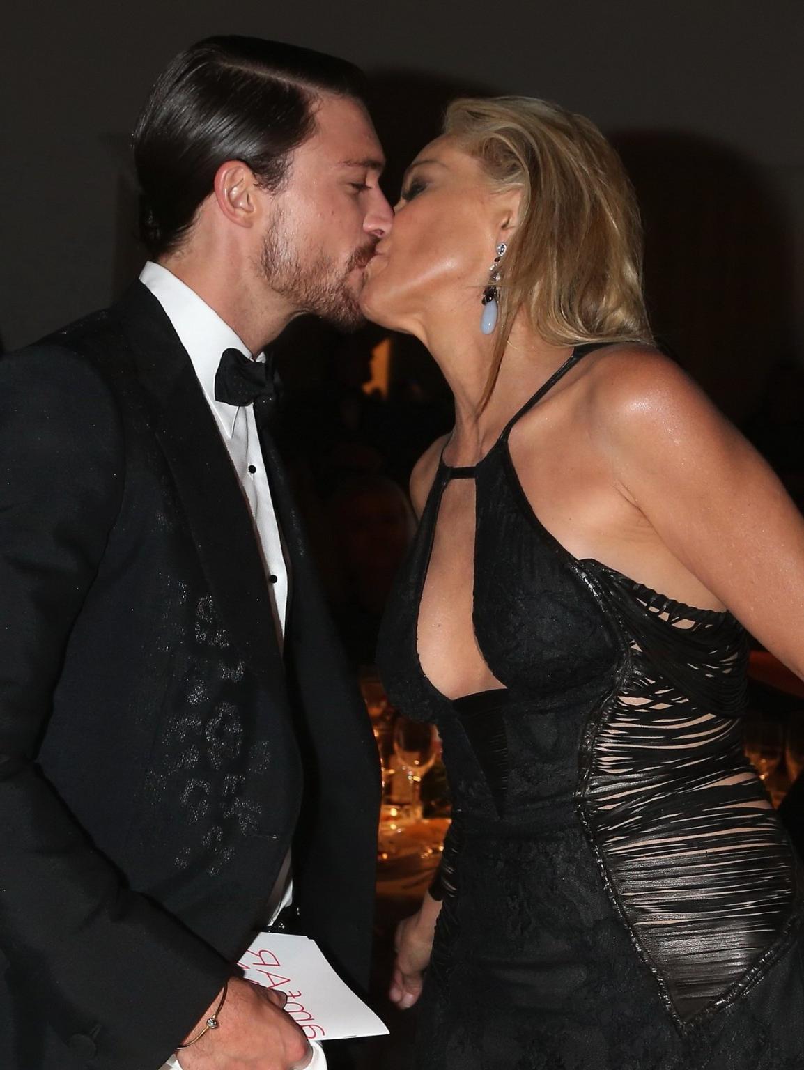 10P Sharon Stone showing cleavage at amfAR event during Milan Fashion Week
