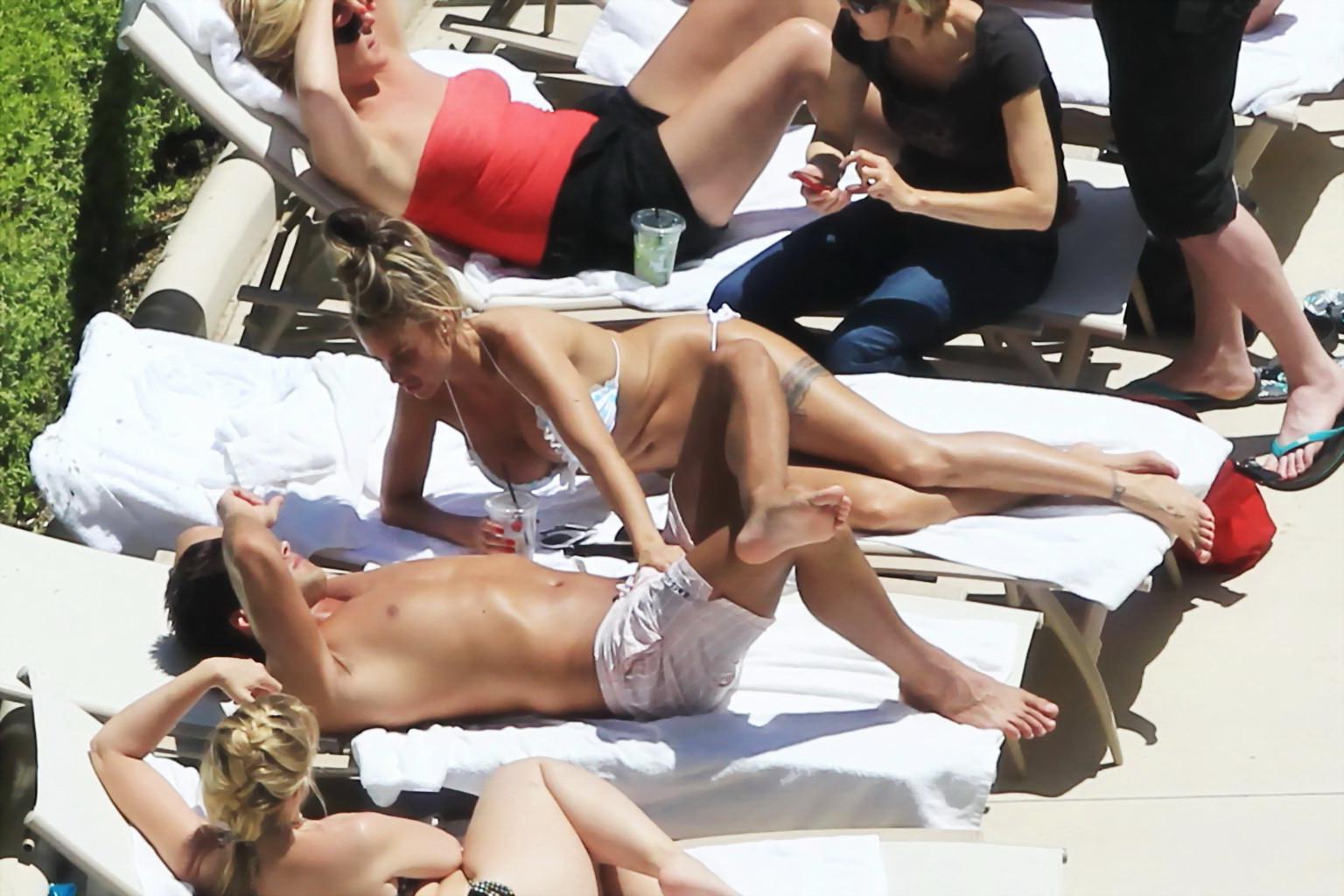 10P Busty babe Katie Price jerking a cock over shorts in public at the pool in Las V
