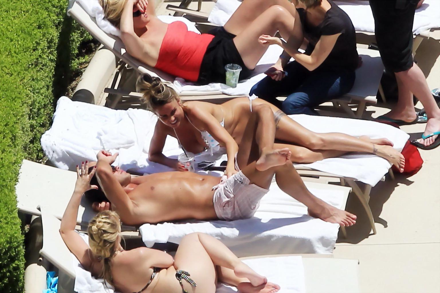 10P Busty babe Katie Price jerking a cock over shorts in public at the pool in Las V