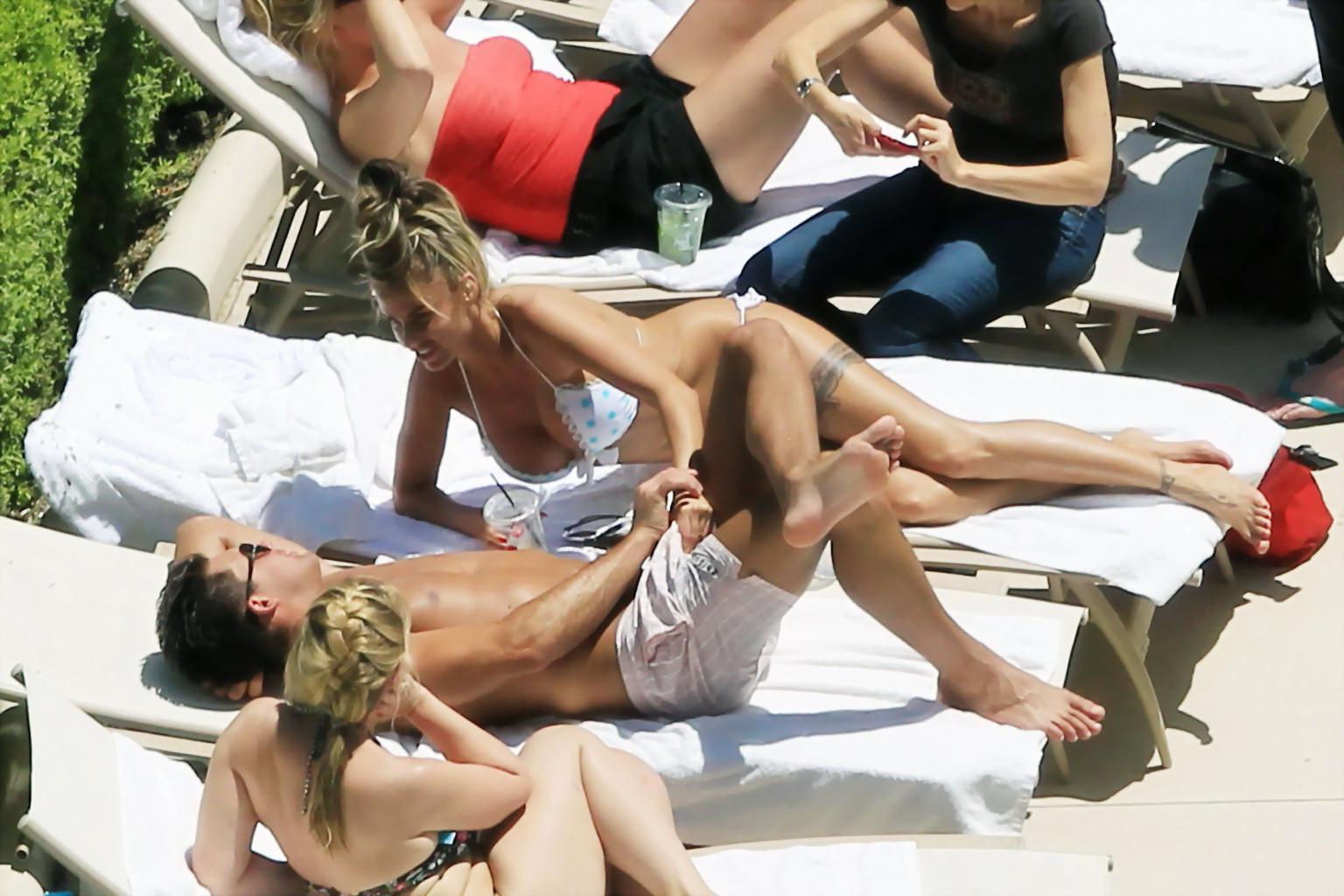 10P Busty babe Katie Price jerking a cock over shorts in public at the pool in Las V