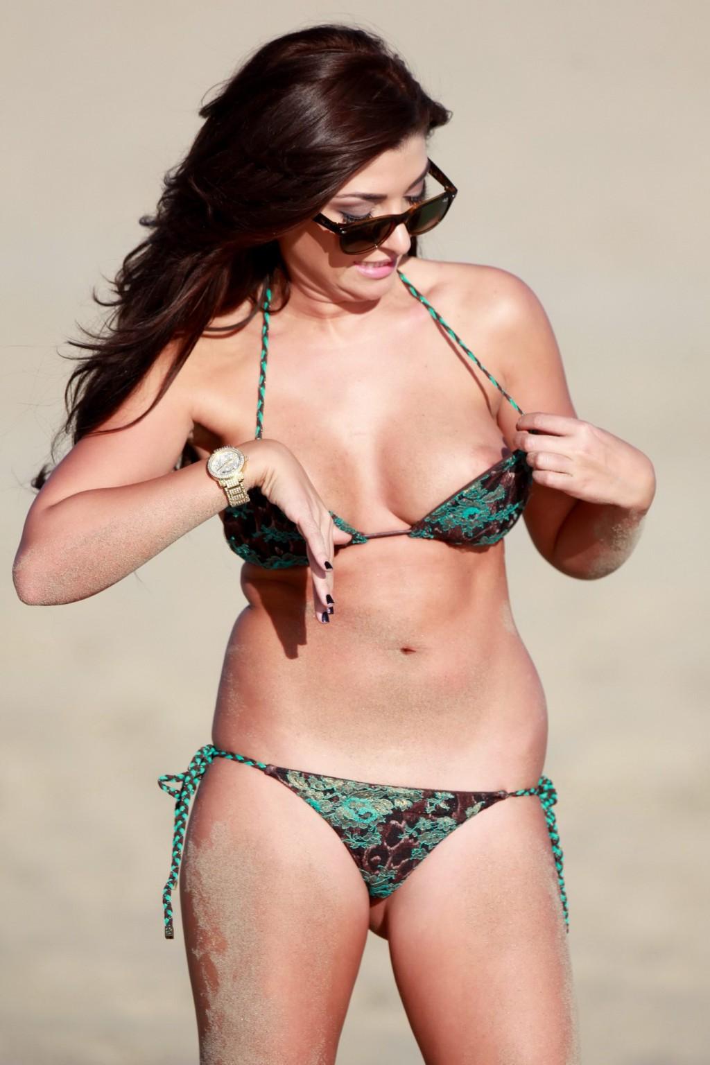 16P Britney Jones bikini nipple slip while sunbathing on a beach