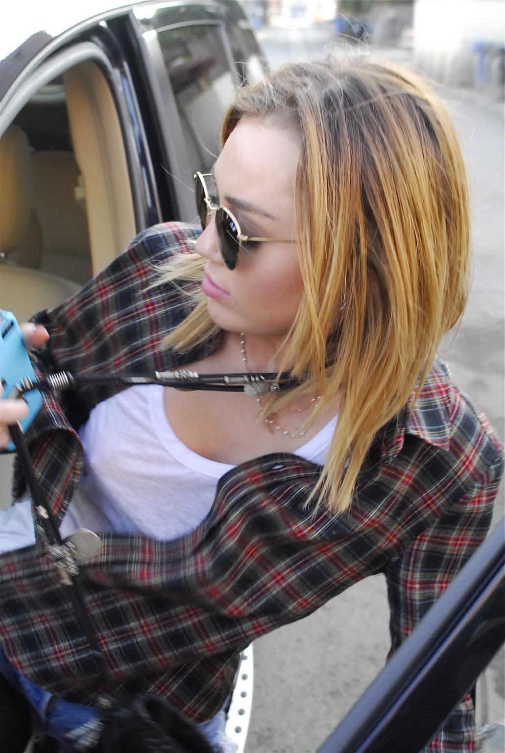 16P Miley Cyrus braless showing pokies outside Wokcano Restaurant in LA