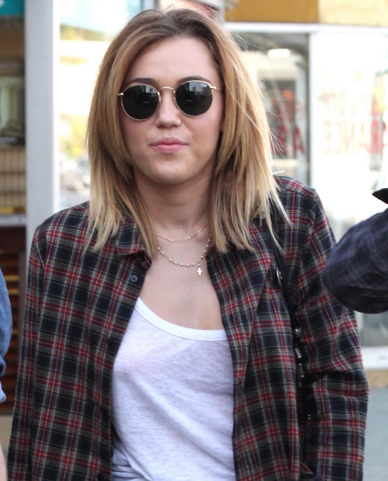 16P Miley Cyrus braless showing pokies outside Wokcano Restaurant in LA
