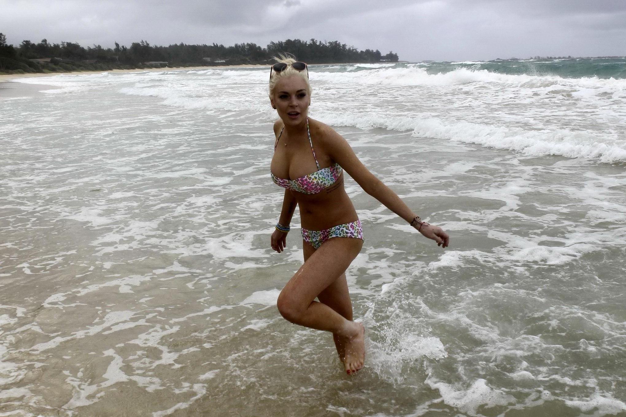 16P Lindsay Lohan bikini nip slip on a beach in Hawaii