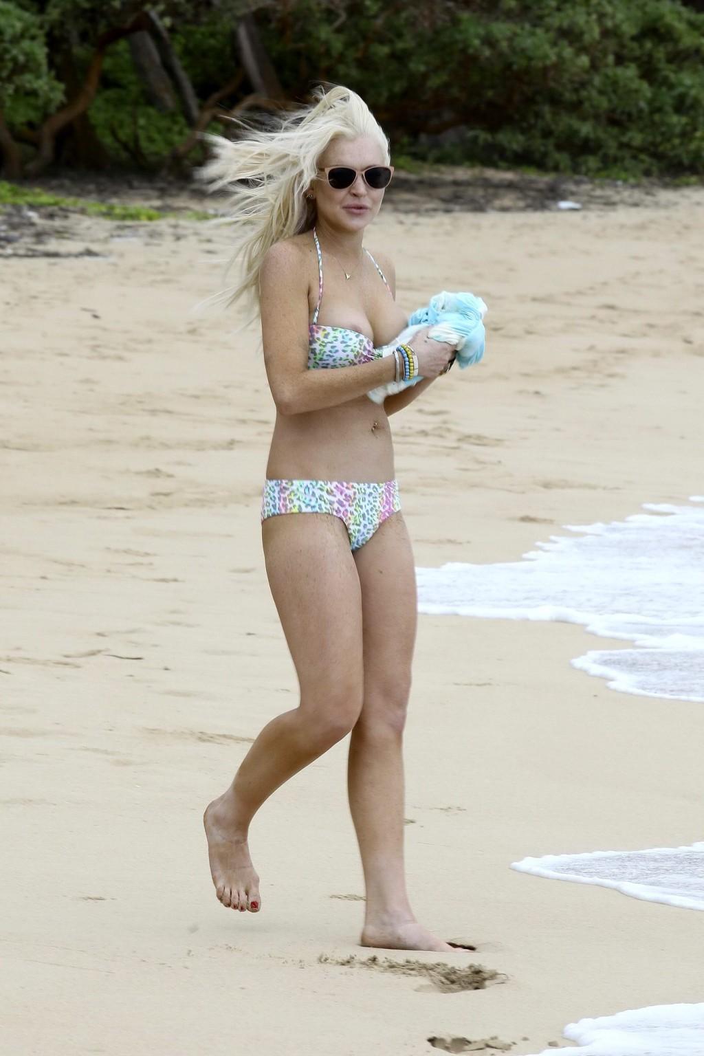 16P Lindsay Lohan bikini nip slip on a beach in Hawaii