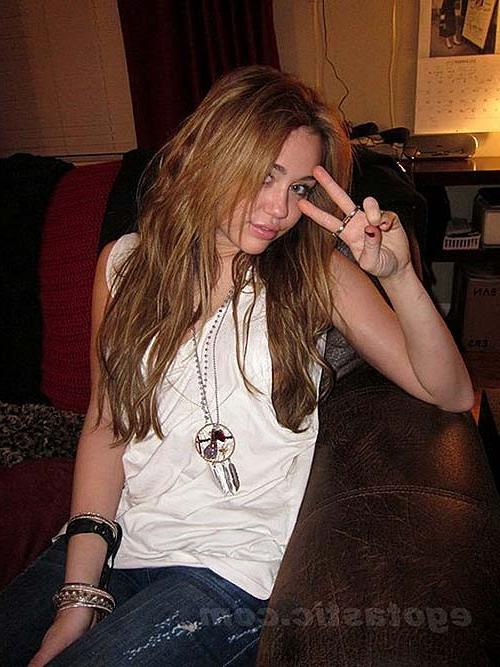 16P Miley Cyrus lying on the bed and exposing her sexy body in underwear