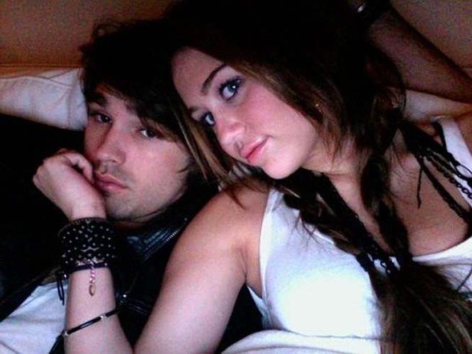 16P Miley Cyrus lying on the bed and exposing her sexy body in underwear