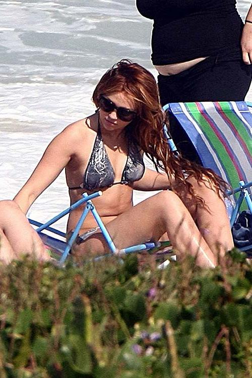 16P Miley Cyrus lying on the bed and exposing her sexy body in underwear