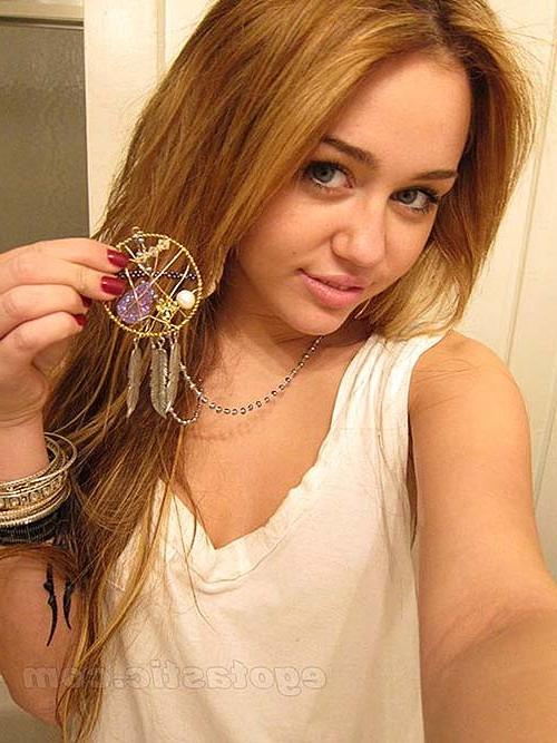 16P Miley Cyrus lying on the bed and exposing her sexy body in underwear