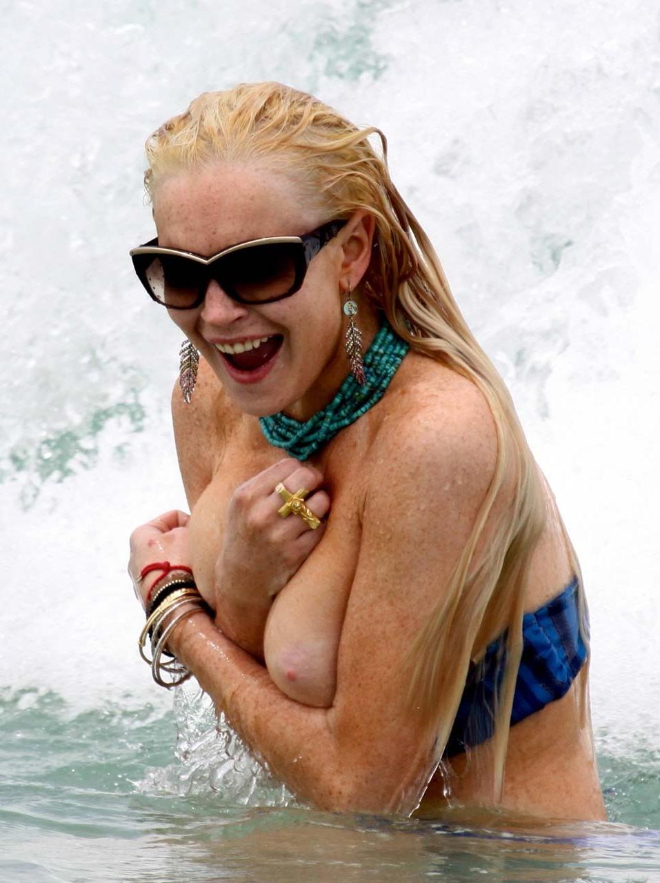 16P Lindsay Lohan tits slip from bikini on beach oops paparazzi pictures