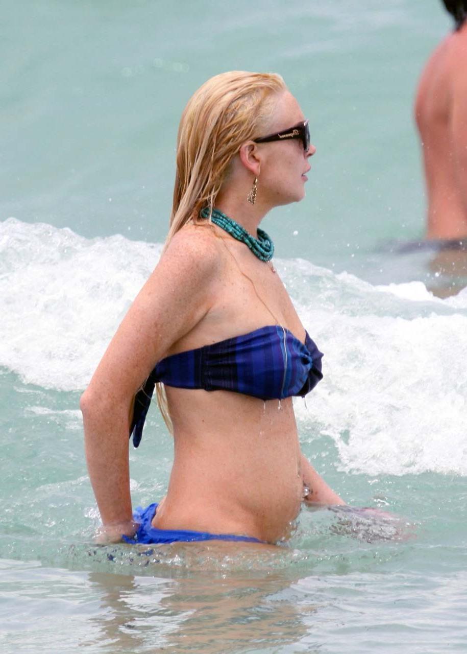 16P Lindsay Lohan tits slip from bikini on beach oops paparazzi pictures