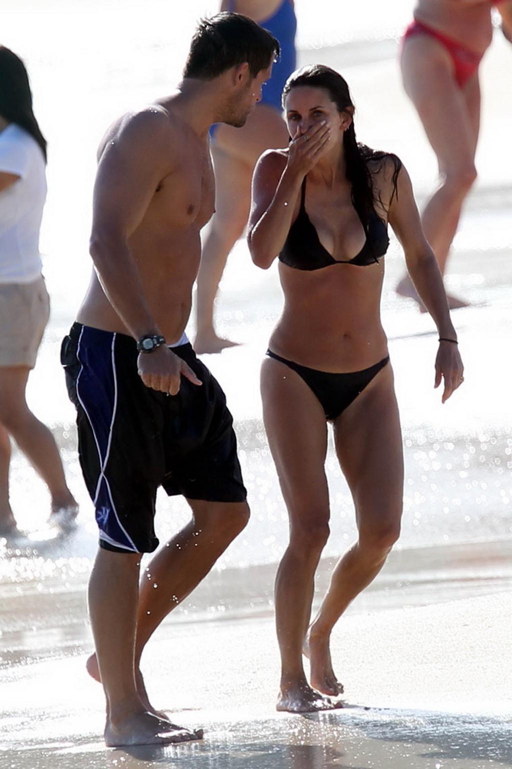 16P Courteney Cox bikini nip slip on the beach in St. Barts
