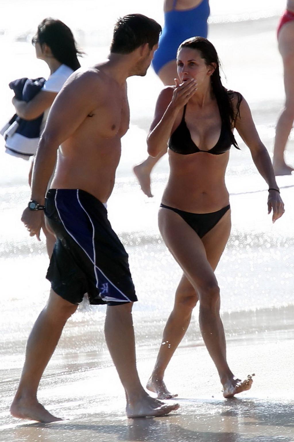16P Courteney Cox bikini nip slip on the beach in St. Barts