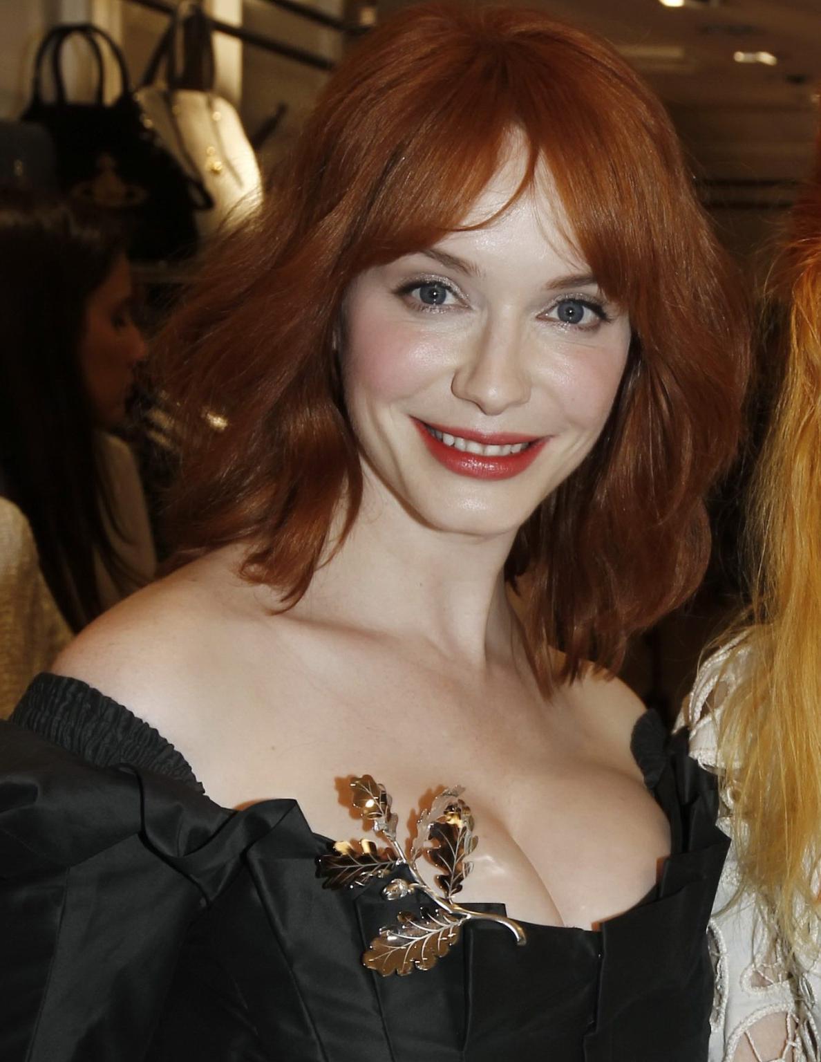 16P Christina Hendricks showing huge cleavage at Vivienne Westwood LA store opening