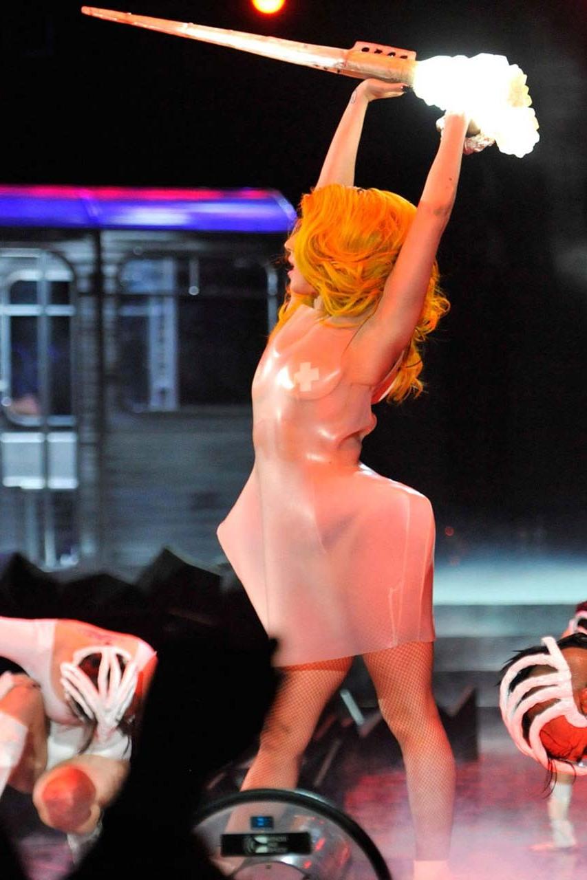 16P Lady Gaga exposing her tits in see thru dress on stage paparazzi pictures