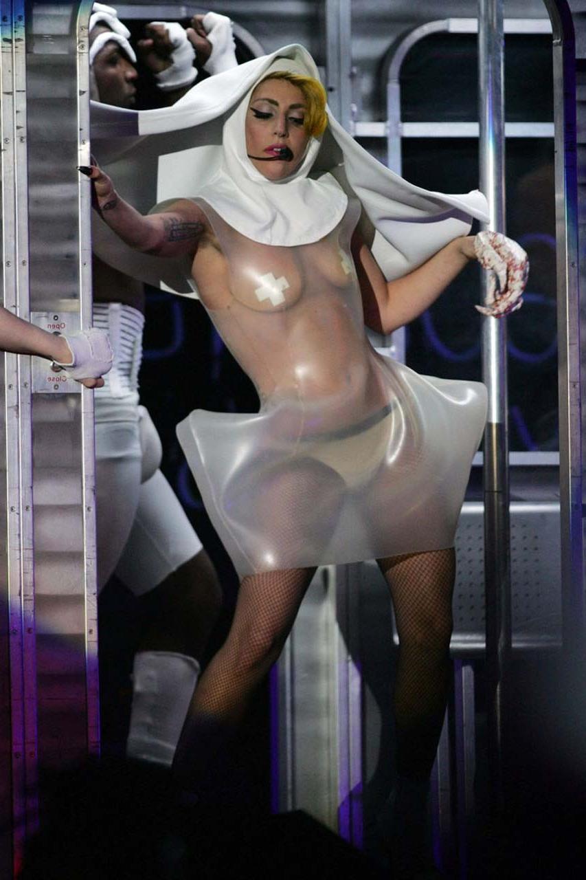 16P Lady Gaga exposing her tits in see thru dress on stage paparazzi pictures
