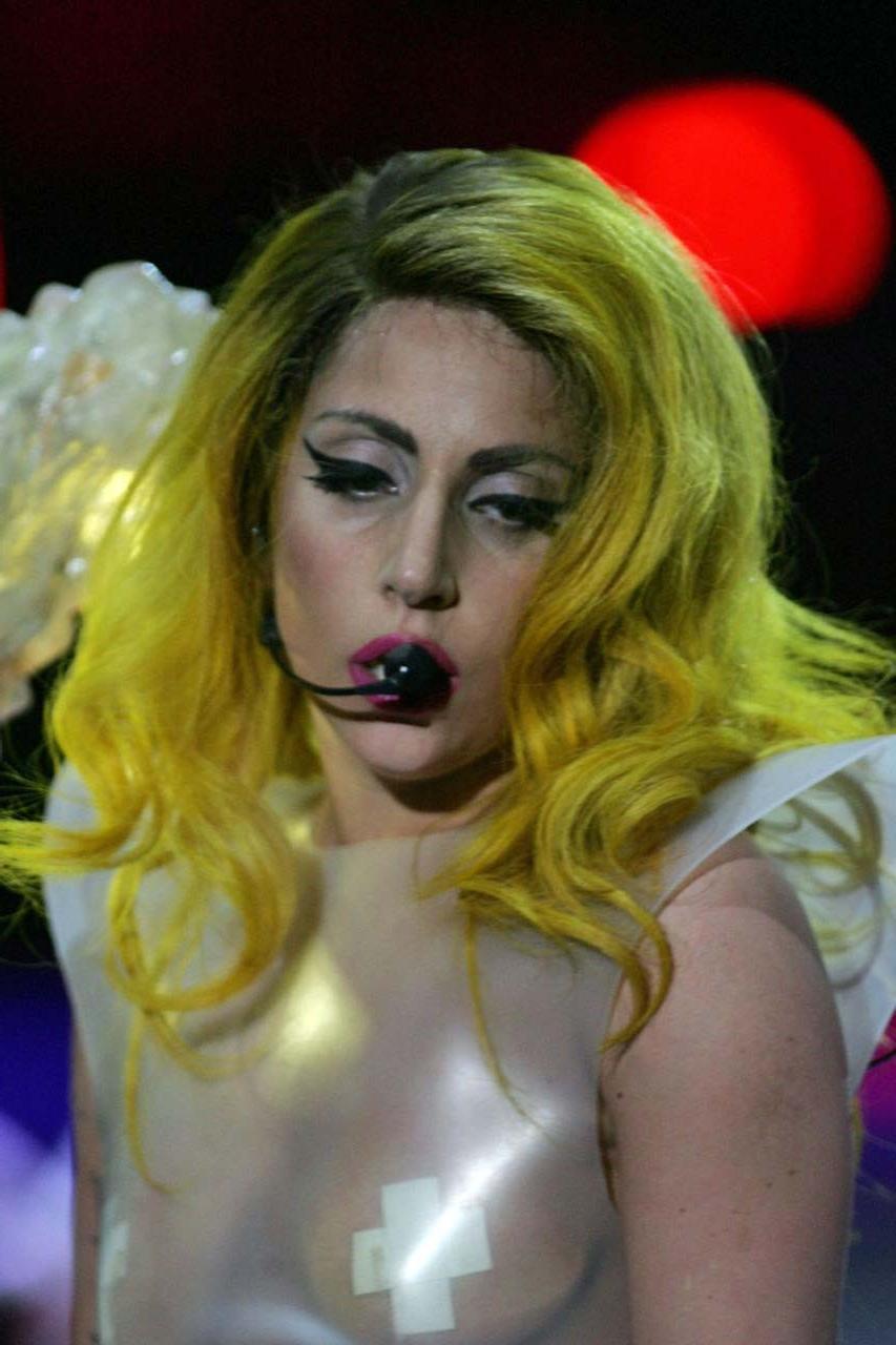 16P Lady Gaga exposing her tits in see thru dress on stage paparazzi pictures
