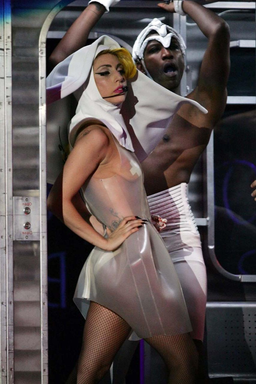 16P Lady Gaga exposing her tits in see thru dress on stage paparazzi pictures