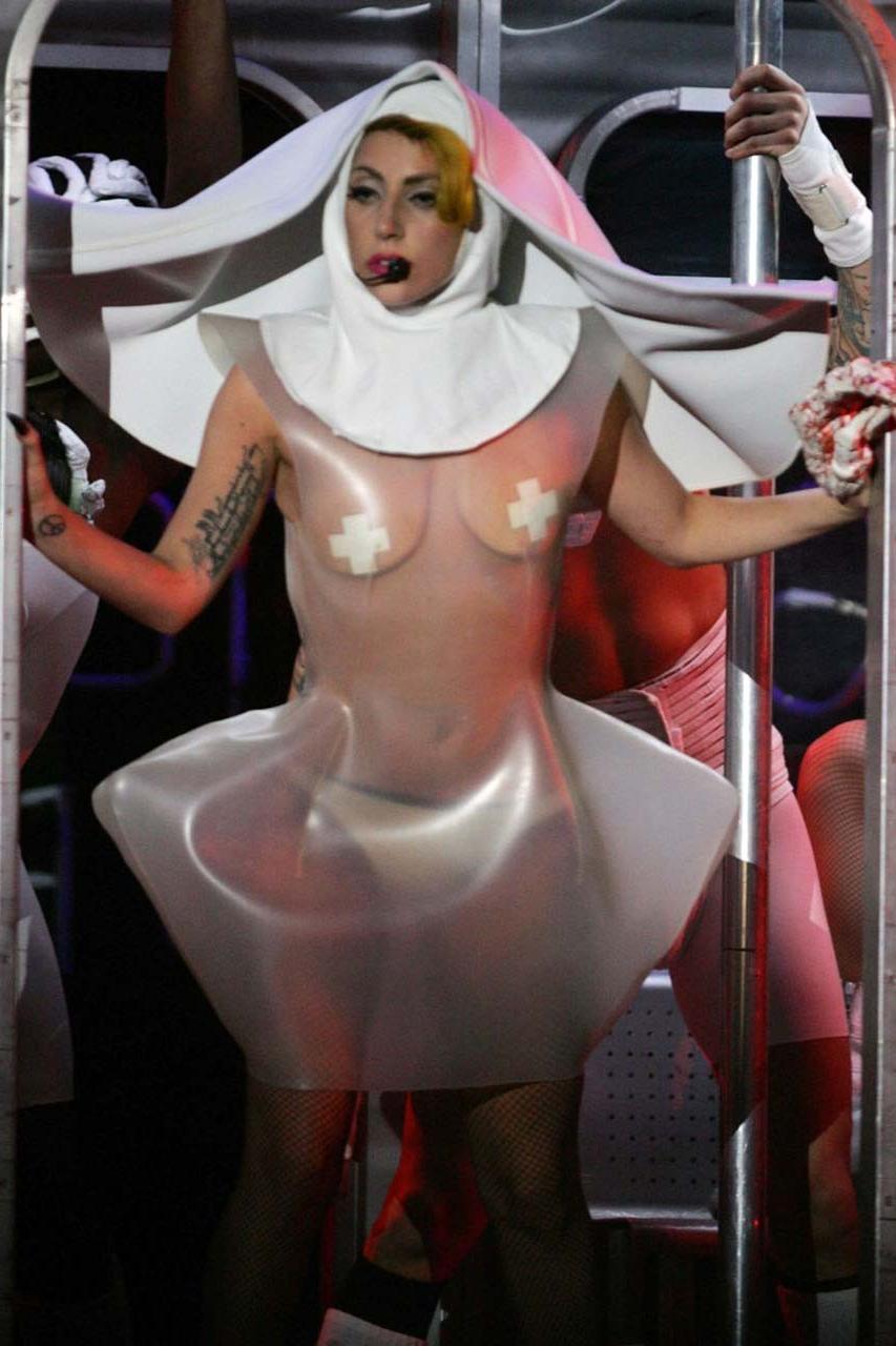 16P Lady Gaga exposing her tits in see thru dress on stage paparazzi pictures