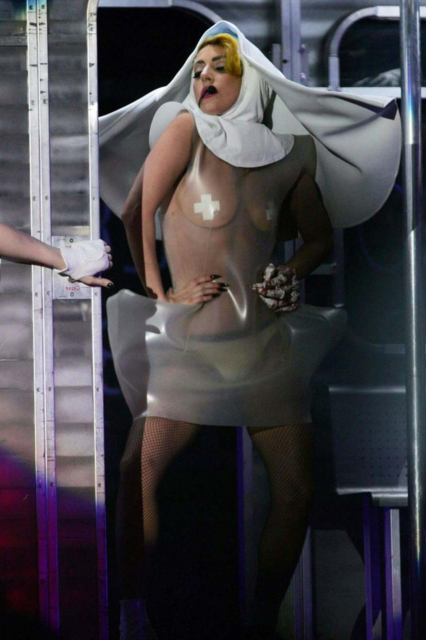 16P Lady Gaga exposing her tits in see thru dress on stage paparazzi pictures