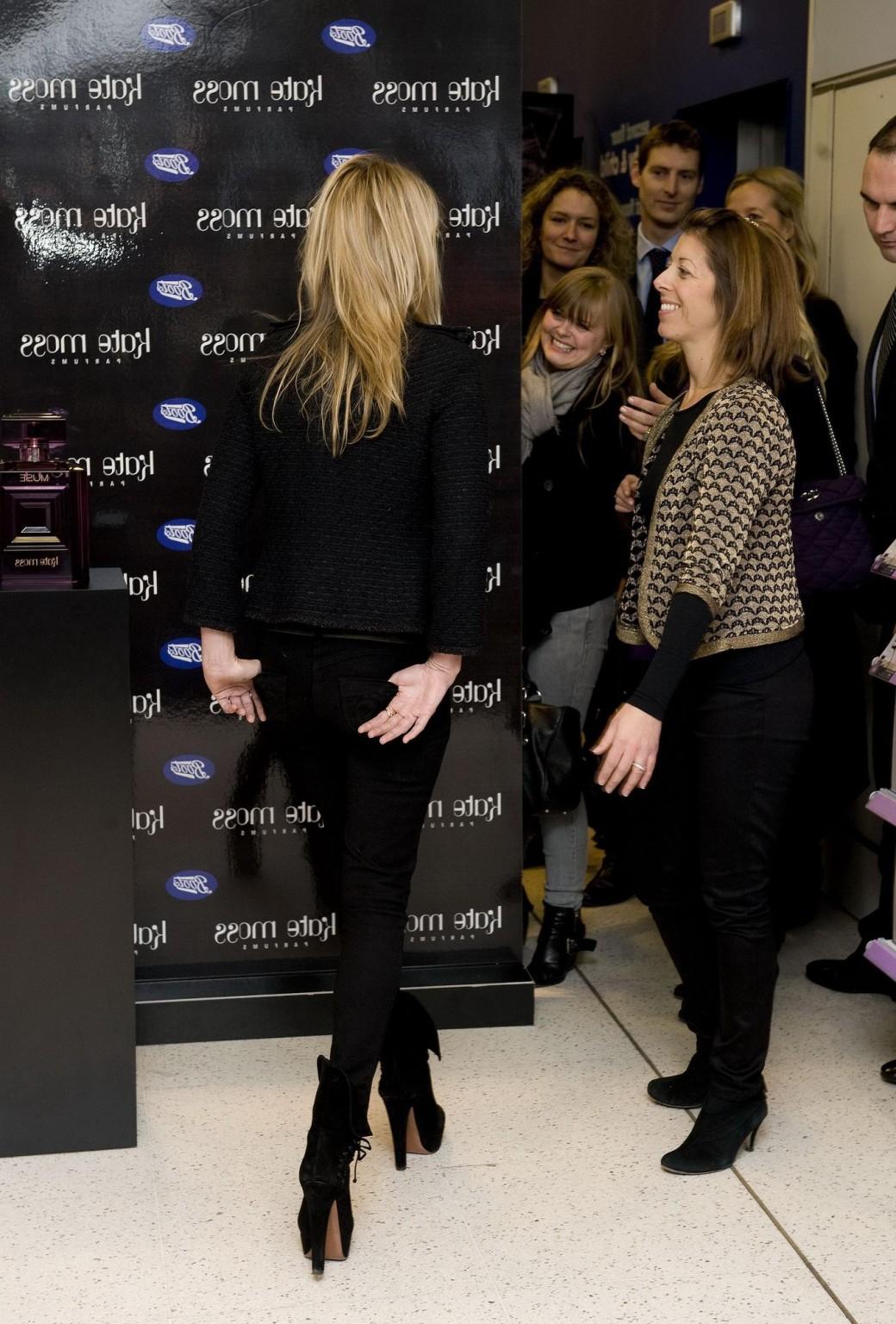 16P Kate Moss braless showing nice cleavage in black top at 'Vintage Muse' fragrance