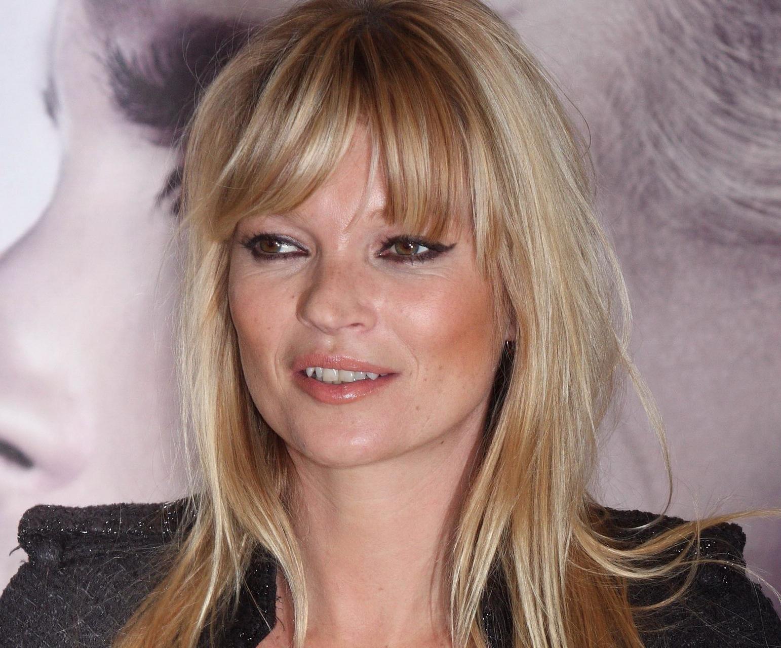 16P Kate Moss braless showing nice cleavage in black top at 'Vintage Muse' fragrance