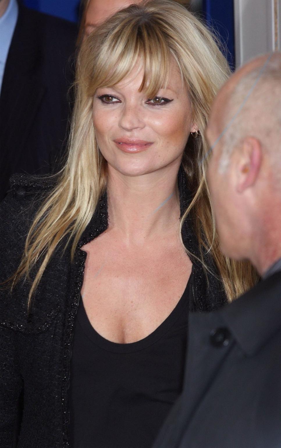 16P Kate Moss braless showing nice cleavage in black top at 'Vintage Muse' fragrance