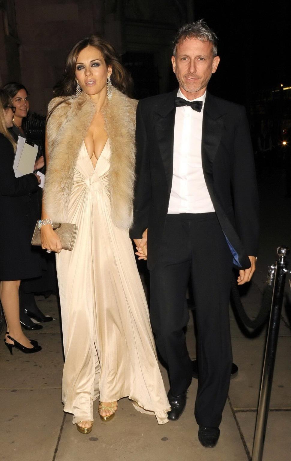 16P Elizabeth Hurley showing massive cleavage heading to Elton John's private party 